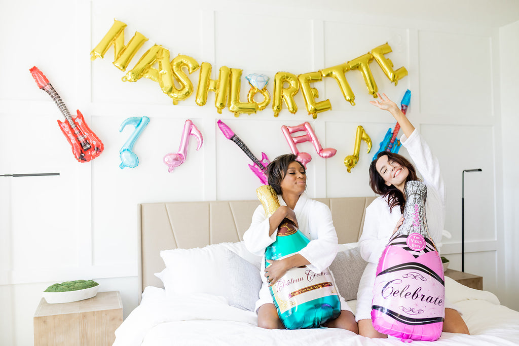 Women using Nashlorette decorations for their Nashville Bachelorette Party